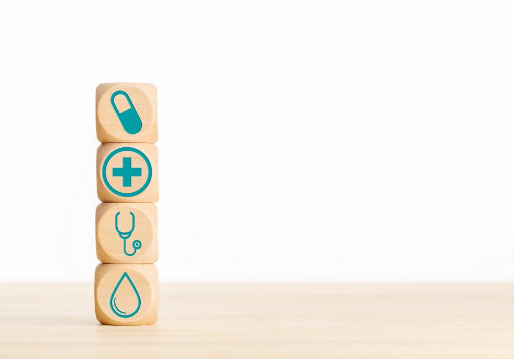 Health care or medicine concept. Wooden blocks with medical icon on table. Copy space
